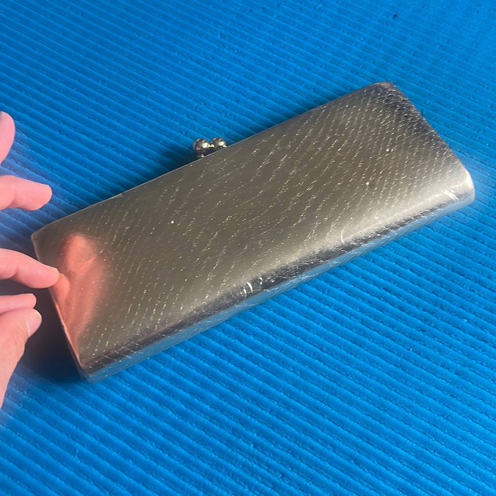 Gold clutch with a little scratch on the front and slightly on the back